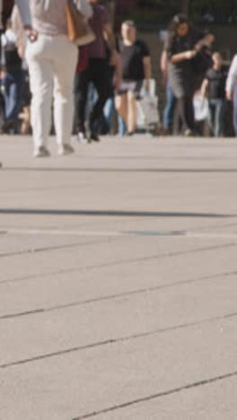 Vertical-Video-Close-Up-Of-London-Commuters-Walking-To-Work-Across-Square-UK